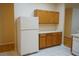 Bright kitchen featuring wood cabinets, white countertops, and appliances, with a white tiled floor at 19432 Haskell Pl, Land O Lakes, FL 34638