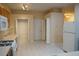 Functional kitchen space including modern white appliances, wooden cabinetry, and tiled flooring at 19432 Haskell Pl, Land O Lakes, FL 34638