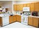 Bright kitchen features updated appliances and ample counter space for meal prep at 19432 Haskell Pl, Land O Lakes, FL 34638