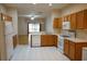Spacious kitchen overlooking the living area, featuring wood cabinets and modern appliances at 19432 Haskell Pl, Land O Lakes, FL 34638