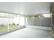 Bright, screened lanai with concrete flooring, complemented by lush green grass and foliage beyond at 19432 Haskell Pl, Land O Lakes, FL 34638