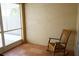 Screened lanai with tile floor and a wooden rocking chair at 19432 Haskell Pl, Land O Lakes, FL 34638