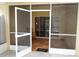 Screened lanai with tile flooring and comfortable seating, perfect for outdoor relaxation at 19432 Haskell Pl, Land O Lakes, FL 34638