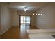 Open living space with wood floors, neutral walls, and a sliding glass door for natural light at 19432 Haskell Pl, Land O Lakes, FL 34638