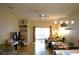 Open-concept living area with wood floors, ceiling fan, and sliding doors to the lanai at 19432 Haskell Pl, Land O Lakes, FL 34638