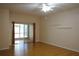 Bright living room with wood floors and sliding glass doors to screened lanai, offering indoor-outdoor living at 19432 Haskell Pl, Land O Lakes, FL 34638
