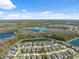 Expansive aerial shot reveals a community dotted with scenic lakes, mature trees, and well-maintained homes in a desirable locale at 2845 Murray Pass, Odessa, FL 33556