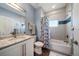 Well-lit bathroom with granite countertops, tiled shower, and coastal accents at 30 79Th Ave, Treasure Island, FL 33706