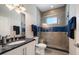 Contemporary bathroom featuring a shower with glass enclosure, stylish lighting, and dark granite vanity at 30 79Th Ave, Treasure Island, FL 33706