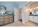 Bedroom with a dresser, TV, closet, and a glimpse into the adjacent bathroom at 30 79Th Ave, Treasure Island, FL 33706