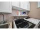 Bright laundry room with washer, dryer, utility sink and built-in cabinetry at 30 79Th Ave, Treasure Island, FL 33706