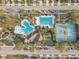 Aerial view of community amenities, including pools, clubhouse, and tennis courts at 34159 Astoria Cir, Wesley Chapel, FL 33545