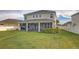 Spacious backyard with lush green grass, a patio, manicured bushes, and a well-maintained lawn at 34159 Astoria Cir, Wesley Chapel, FL 33545