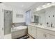 Modern bathroom with a soaking tub, a tiled shower, and double vanity sinks at 34159 Astoria Cir, Wesley Chapel, FL 33545