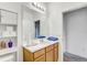 Neutral bathroom featuring a white sink, wood cabinet and a shelf for towels at 34159 Astoria Cir, Wesley Chapel, FL 33545