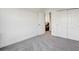 Bedroom featuring gray carpeting and an open door leading to additional spaces at 34159 Astoria Cir, Wesley Chapel, FL 33545