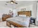Charming bedroom with a rustic wood bed frame and a ceiling fan at 34159 Astoria Cir, Wesley Chapel, FL 33545