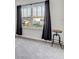 Bedroom featuring a window with gray drapes and an industrial style side table at 34159 Astoria Cir, Wesley Chapel, FL 33545