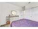 Comfortable bedroom with a dresser, mirror, and a view into the hallway at 34159 Astoria Cir, Wesley Chapel, FL 33545