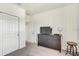 Neutral bedroom featuring a dresser with television and gray carpeting at 34159 Astoria Cir, Wesley Chapel, FL 33545