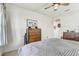 Bright bedroom featuring a dresser with a light and ceiling fan at 34159 Astoria Cir, Wesley Chapel, FL 33545