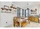 Dining area with a wooden table and bench seating, complemented by decorative shelving and natural light at 34159 Astoria Cir, Wesley Chapel, FL 33545