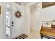 Bright entryway featuring light tile floors, decorative wreath and home decor at 34159 Astoria Cir, Wesley Chapel, FL 33545