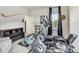 Bright exercise room featuring an elliptical, free weights, and entertainment unit at 34159 Astoria Cir, Wesley Chapel, FL 33545