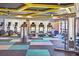 Bright gym featuring state of the art treadmills, fitness equipment, and a unique, geometric patterned floor at 34159 Astoria Cir, Wesley Chapel, FL 33545