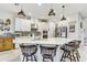 Bright kitchen boasts an island with bar stool seating, stainless steel appliances, and modern lighting fixtures at 34159 Astoria Cir, Wesley Chapel, FL 33545