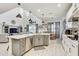 Spacious open floor plan kitchen featuring an island with a breakfast bar, stainless steel appliances, and ample storage at 34159 Astoria Cir, Wesley Chapel, FL 33545
