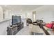 Upstairs living room with a comfortable seating area and a TV on a wood console at 34159 Astoria Cir, Wesley Chapel, FL 33545