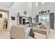 Open-concept living room with high ceilings, modern decor, and abundant natural light at 34159 Astoria Cir, Wesley Chapel, FL 33545
