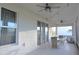 Covered patio with ceiling fans, dining table, and outdoor seating area perfect for entertaining guests at 34159 Astoria Cir, Wesley Chapel, FL 33545