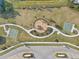 Aerial view of playground with swings and slides surrounded by walking paths and trees at 34159 Astoria Cir, Wesley Chapel, FL 33545