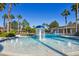 Beautiful resort-style pool featuring a water feature and lush landscaping at 34159 Astoria Cir, Wesley Chapel, FL 33545