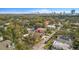 Aerial view of neighborhood with charming home nestled among lush trees and a downtown skyline at 3419 W Empedrado St, Tampa, FL 33629
