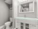 Elegant bathroom showcasing a stylish vanity, toilet, and patterned tile floor at 3419 W Empedrado St, Tampa, FL 33629