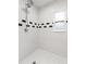 Bathroom shower stall featuring subway tile with black accent tiles at 3419 W Empedrado St, Tampa, FL 33629
