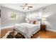 Bright bedroom featuring hardwood floors, a ceiling fan, and natural light at 3419 W Empedrado St, Tampa, FL 33629