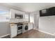 Charming kitchen featuring stainless steel appliances, tile backsplash, and open living space at 3419 W Empedrado St, Tampa, FL 33629