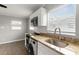 Bright kitchen showcasing white cabinetry, stainless steel appliances, and granite countertops at 3419 W Empedrado St, Tampa, FL 33629