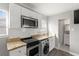 Bright kitchen showcasing white cabinetry, stainless steel appliances, and granite countertops at 3419 W Empedrado St, Tampa, FL 33629