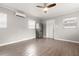 Open living room with wood flooring, stainless refrigerator and a ceiling fan at 3419 W Empedrado St, Tampa, FL 33629
