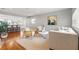 Bright living area with hardwood floors, neutral tones, and a view into an open kitchen at 3419 W Empedrado St, Tampa, FL 33629