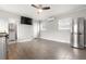 Open living room with wood flooring, a ceiling fan, and abundant natural light at 3419 W Empedrado St, Tampa, FL 33629