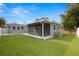 Backyard featuring a screened in porch and artificial turf at 3419 W Empedrado St, Tampa, FL 33629