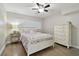 Cozy bedroom with wood floors, a white frame bed and a large window with blinds at 3717 46Th S Ave # 7, St Petersburg, FL 33711