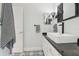 Modern bathroom with white vanity, black countertop, and rectangular sink with black and white accents at 4442 Clairson Ct, Palm Harbor, FL 34685