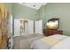 Large primary bedroom with ensuite bathroom access, high ceilings, and bright green walls at 4442 Clairson Ct, Palm Harbor, FL 34685